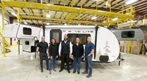 Travel Lite COO and General Manager Ryan Rebar (L) poses in front of the new Rove Lite with team members
