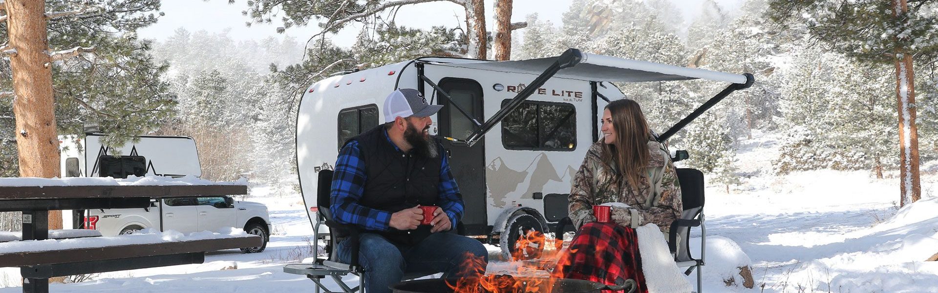 Travel Lite Rove Lite ultralight travel trailer with aerodynamic teardrop design, Hydro-Lite construction, seamless fiberglass roof, solid surface countertops, and convertible beds for space-saving functionality.